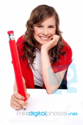 Teenage Pupil Writing With Pencil Stock Photo