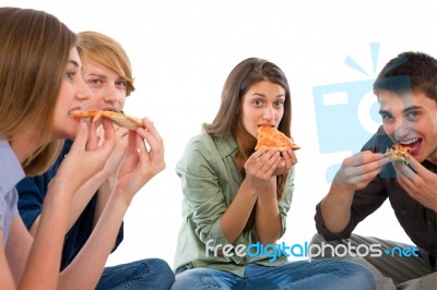 Teenagers Eating Pizza Stock Photo