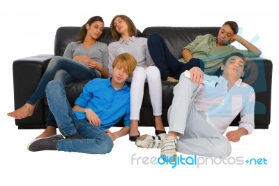 Teenagers Sleeping On Sofa Stock Photo