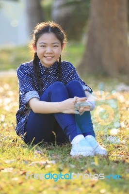 Thai 12s Years Girl Sitting On Garden Field Toothy Smiling Face Happiness Emotion Stock Photo