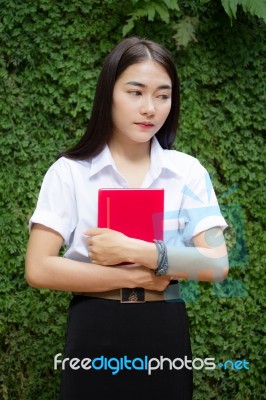 Thai Adult Student University Beautiful Girl Reading Red Book Stock Photo