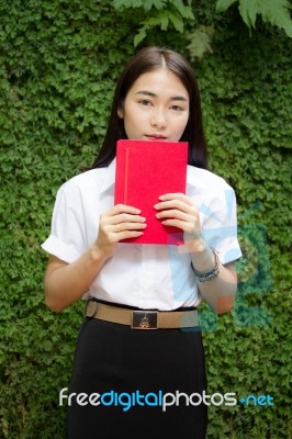 Thai Adult Student University Beautiful Girl Reading Red Book Stock Photo