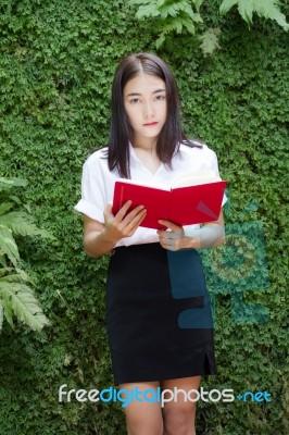 Thai Adult Student University Beautiful Girl Reading Red Book Stock Photo