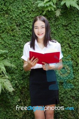 Thai Adult Student University Beautiful Girl Reading Red Book Stock Photo