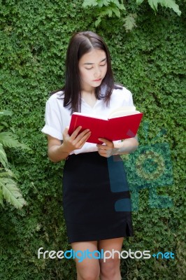 Thai Adult Student University Beautiful Girl Reading Red Book Stock Photo