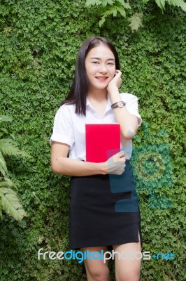 Thai Adult Student University Beautiful Girl Reading Red Book Stock Photo