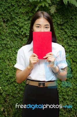 Thai Adult Student University Beautiful Girl Reading Red Book Stock Photo