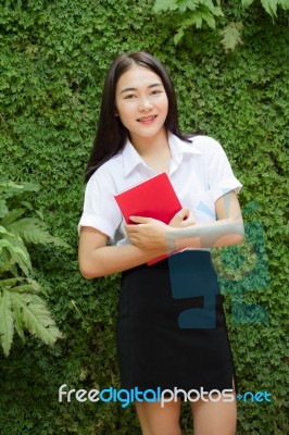 Thai Adult Student University Beautiful Girl Reading Red Book Stock Photo