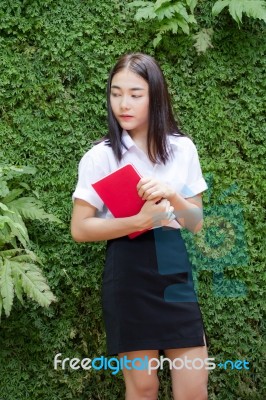 Thai Adult Student University Beautiful Girl Reading Red Book Stock Photo