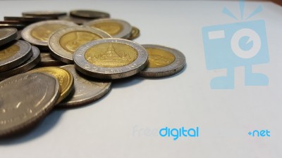 Thai Baht Coins On White Paper.side View Stock Photo