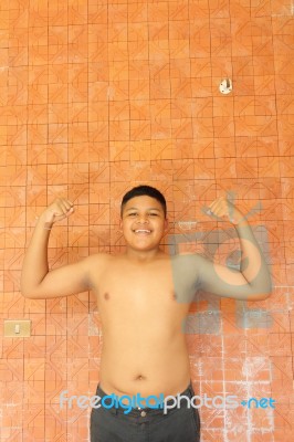 Thai Boy Muscle Flexing Stock Photo