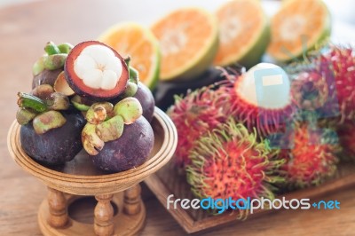 Thai Tropical Fruit On Wooden Table Stock Photo