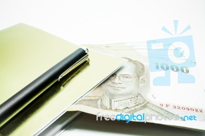 Thailand Banknotes Arranged In Set And  Note Book Stock Photo