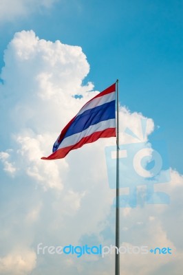 Thailand Flag Against Clouds And Blue Sky Stock Photo