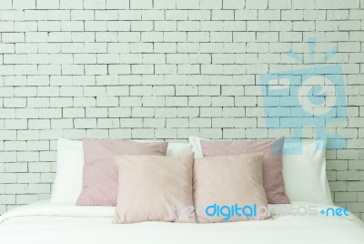 The Bed On White Bricks Wall Background Stock Photo