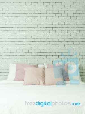 The Bed On White Bricks Wall Background Vertical Stock Photo