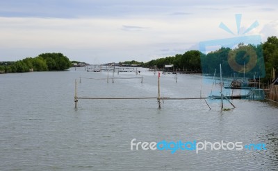 The Canal With Fish Poles Stock Photo