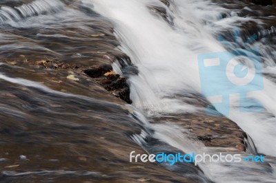 The Fast Water Movement In A Creek Stock Photo