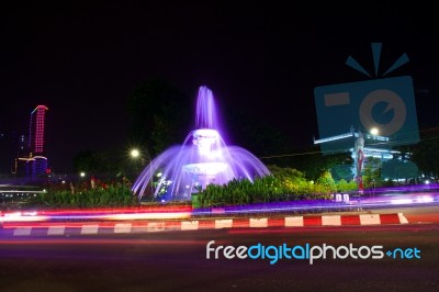 The Fountain At The City Intersection With The Building's Background Towering High Behind Stock Photo