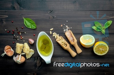 The Ingredients For Green Pesto Sauce On Dark Wooden Background Stock Photo