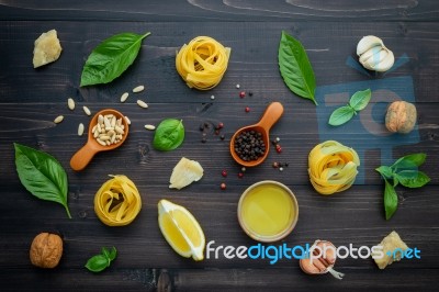 The Ingredients For Green Pesto Sauce On Dark Wooden Background Stock Photo