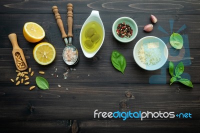 The Ingredients For Green Pesto Sauce On Dark Wooden Background Stock Photo