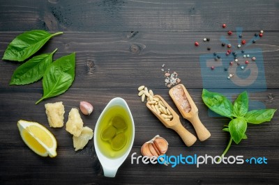 The Ingredients For Green Pesto Sauce On Dark Wooden Background Stock Photo