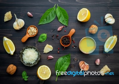 The Ingredients For Green Pesto Sauce On Dark Wooden Background Stock Photo