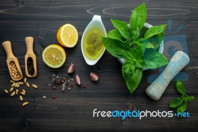 The Ingredients For Green Pesto Sauce On Dark Wooden Background Stock Photo