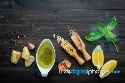 The Ingredients For Green Pesto Sauce On Dark Wooden Background Stock Photo