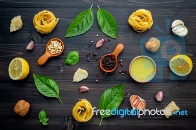 The Ingredients For Green Pesto Sauce On Dark Wooden Background Stock Photo