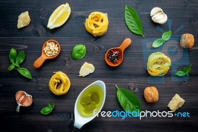 The Ingredients For Green Pesto Sauce On Dark Wooden Background Stock Photo