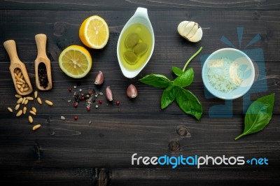 The Ingredients For Green Pesto Sauce On Dark Wooden Background Stock Photo