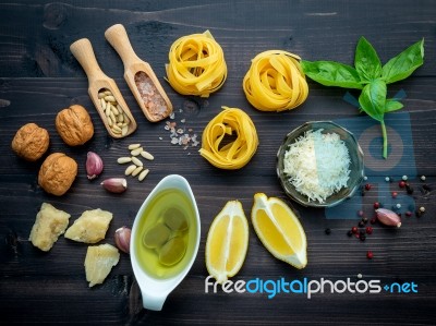 The Ingredients For Green Pesto Sauce On Dark Wooden Background Stock Photo