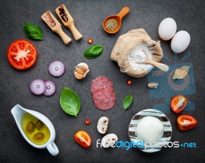 The Ingredients For Homemade Pizza On Dark Stone Background Stock Photo