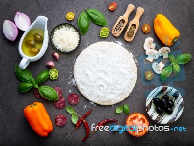 The Ingredients For Homemade Pizza On Dark Stone Background Stock Photo