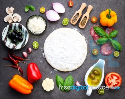 The Ingredients For Homemade Pizza On Dark Stone Background Stock Photo