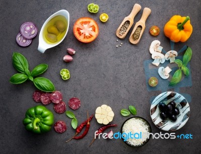 The Ingredients For Homemade Pizza On Dark Stone Background Stock Photo