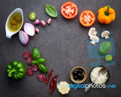 The Ingredients For Homemade Pizza On Dark Stone Background Stock Photo