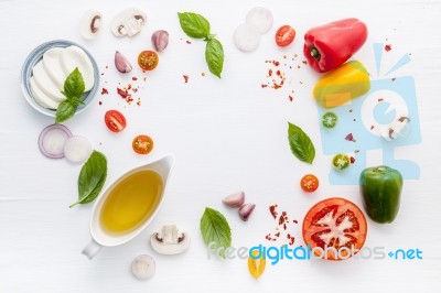 The Ingredients For Homemade Pizza On White Wooden Background Stock Photo