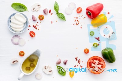 The Ingredients For Homemade Pizza On White Wooden Background Stock Photo