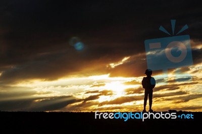 The Lonely Girl At Sunset Stock Photo