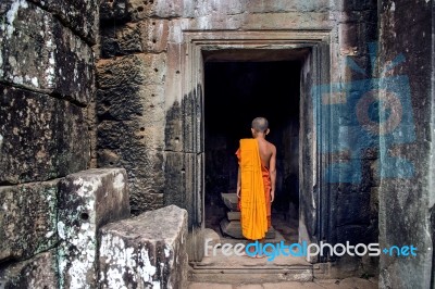 The Monks In The Ancient Stone Faces Of Bayon Temple, Angkor Wat, Siam Reap, Cambodia Stock Photo