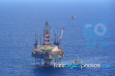 The Offshore Drilling Oil Rig And Supply Boat Side View Stock Photo