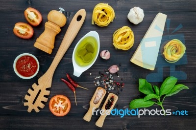 The  Pasta On Black Wooden Background. Yellow Italian Pasta With… Stock Photo