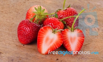 The Strawberry On Wood Background Stock Photo