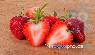 The Strawberry On Wood Background Stock Photo