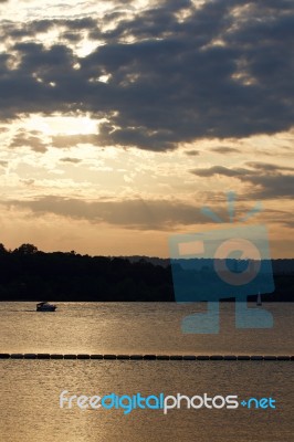 The Sunset On The Lake With Two Yachts Stock Photo