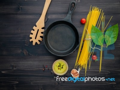 The Thin Spaghetti On Black Wooden Background. Yellow Italian Pa… Stock Photo