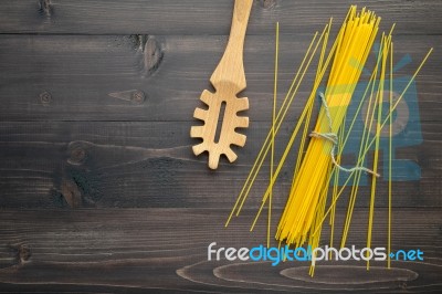 The Thin Spaghetti On Black Wooden Background. Yellow Italian Pa… Stock Photo